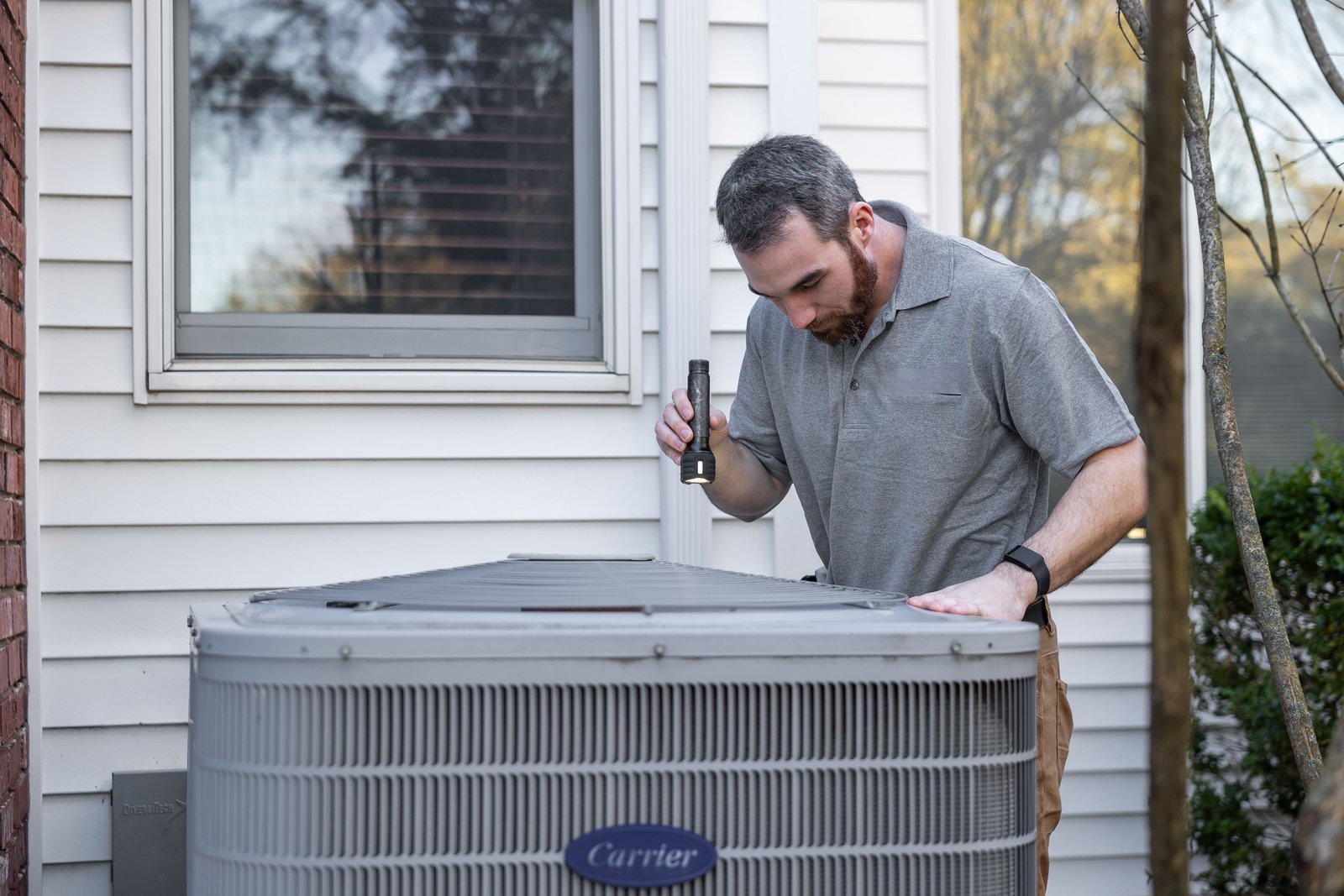 HVAC technician inspecting outdoor equipment